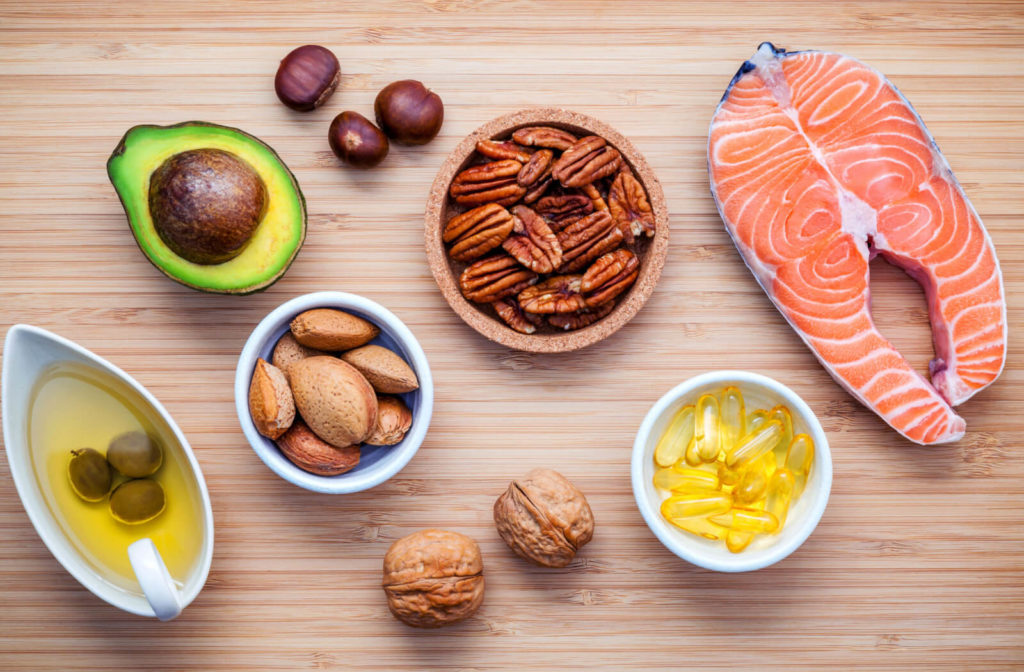 selection of food that is a good source of omega-3 and gel capsules of omega-3 on the table.