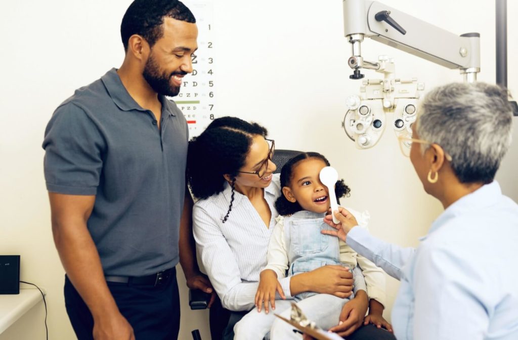 A family takes their daughter to get her sight tested at her first eye exam