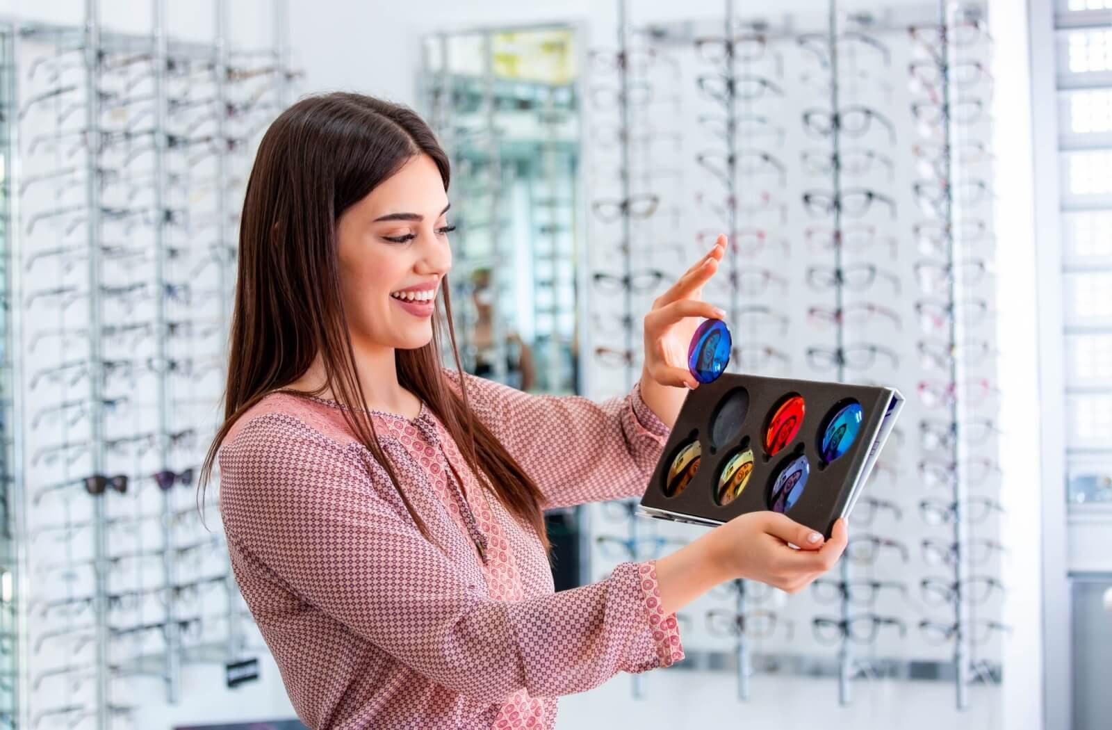 An optician holding the different kind of lens colours you can get with polarized sunglasses